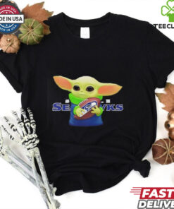 Baby Yoda holding Seattle Seahawks football shirt