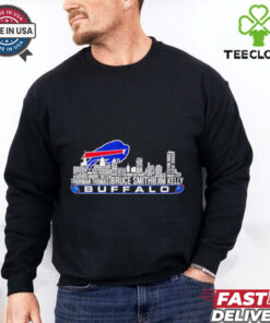 For a **Buffalo Bills shirt featuring Thurman Thomas, Bruce Smith, Jim Kelly, and a city skyline**, here's a detailed design concept: **Design Elements**: - **Central Feature**: The **Buffalo Bills logo** in the center, prominently displayed in vibrant **Buffalo blue** and **red** with a metallic shine. It can be **3D-styled** to pop against the background. - **City Skyline**: A **detailed silhouette of Buffalo city skyline** (including recognizable buildings and landmarks) should be incorporated behind the logo. The skyline should be in shades of **grey or black** to ensure the focus remains on the logo and players. Adding a subtle glow or light effect could make the skyline feel more dynamic. - **Player Images**: - **Thurman Thomas**, **Bruce Smith**, and **Jim Kelly** should be included in **action poses**, either in a **side-by-side layout** or in a **triangular formation**. They should have a slightly **retro-style treatment**, capturing their iconic moments. Use an **artistic illustration** style rather than direct photos to keep the design cohesive and unique. - Each player’s **name and number** should be placed underneath their image (e.g., **Thurman Thomas #34**, **Bruce Smith #78**, **Jim Kelly #12**) in bold, **athletic-style font**. - **Text Elements**: - Across the top or bottom of the design, include the text **