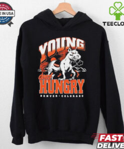 The **Denver Broncos Young and Hungry Shirt** captures the energy and determination of the team, highlighting the fresh talent eager to make an impact. A perfect shirt for fans to support the next generation of Broncos players!