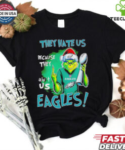 Eagles Super Bowl Grinch Christmas They Hate Us Because They Ain't Us Shirt featuring a playful Grinch design with a bold statement celebrating the Philadelphia Eagles' Super Bowl victory and confidence during the holiday season.