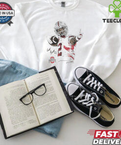 The **Emeka Egbuka Bullseye Cartoon Shirt** features a dynamic and fun cartoon-style design of Emeka Egbuka, with a 