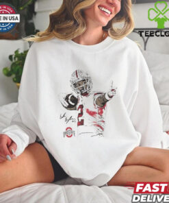 The **Emeka Egbuka Bullseye Cartoon Shirt** features a dynamic, fun design of the standout wide receiver, Emeka Egbuka, with a bullseye graphic. A great way for fans to show their support in a playful style!