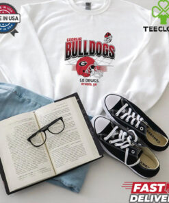 The **Georgia Bulldogs Football Go Dawgs Helmet Grid Shirt** features a dynamic design with the iconic Georgia Bulldogs football helmet and a grid layout. A perfect shirt for fans to show their support for the Bulldogs and their fierce team spirit!