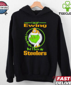 Grinch Christmas I Am An Ewing I Love My Pittsburgh Steelers Shirt featuring a festive design with a playful Grinch theme, expressing loyalty to the Pittsburgh Steelers.