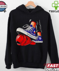 Kamala chucks stepping on Trump hat shirt