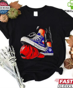 Kamala chucks stepping on Trump hat shirt