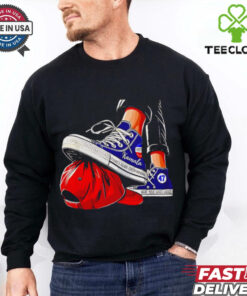 Kamala chucks stepping on Trump hat shirt