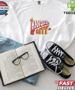 The **Kansas City Football Stickers Shirt** features a fun and colorful design with various football-themed stickers, showcasing Kansas City’s football pride. A playful and stylish shirt for fans who want to show off their love for the team in a unique and creative way!