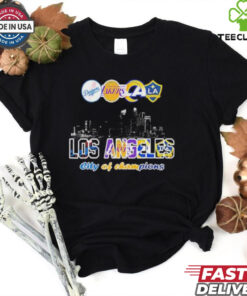 Los Angeles Dodgers x Los Angeles Lakers x Los Angeles Rams x Los Angeles Galaxy City Skyline Los Angeles City of Champions T-shirt featuring a dynamic design that celebrates the city's legendary sports teams. Show your pride for Los Angeles as the City of Champions with this iconic, all-in-one apparel for fans of every L.A. team.