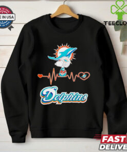 Miami Dolphins x Snoopy Player Heartbeat Shirt, featuring a fun and stylish design that combines the Miami Dolphins logo and Snoopy in a heartwarming graphic. Perfect for fans who love both the Dolphins and the Peanuts character, celebrating their passion for the team with a playful twist.