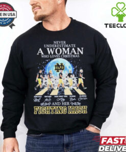 Never Underestimate A Woman Who Loves Christmas And Her Notre Dame Fighting Irish Abbey Road Signatures Shirt