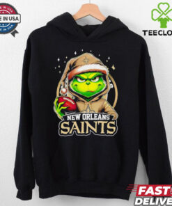 New Orleans Saints Grinch wearing Santa hat Christmas 2024 shirt