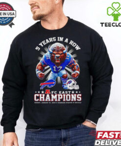 The **Official 5 Years in a Row AFC East Champions Mascot Shirt** celebrates a remarkable achievement for the team, featuring their mascot and the iconic AFC East Championship recognition. A must-have for fans who want to show their pride in this impressive streak of success!
