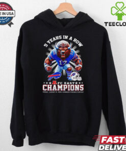 The **Official 5 Years in a Row AFC East Champions Mascot Shirt** celebrates a remarkable achievement for the team, featuring their mascot and the iconic AFC East Championship recognition. A must-have for fans who want to show their pride in this impressive streak of success!
