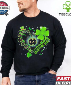 The **Official Clover Heart Notre Dame Fighting Irish Shirt** combines team pride with a unique clover heart design. Perfect for fans of the Fighting Irish who want to showcase their love for the team in a stylish and meaningful way!