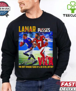 The **Official Lamar Passes Vick the Most Rushing Yards by a QB in NFL History Shirt** honors Lamar Jackson’s record-breaking achievement as the QB with the most rushing yards in NFL history. Featuring bold graphics, this shirt is perfect for fans celebrating Lamar’s historic milestone!
