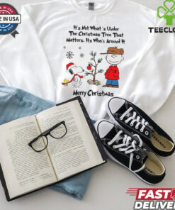 Official Snoopy Charlie Brown And Woodstock It’s Not What’s Under The Tree That Matters It’s What’s Around It Merry Christmas 2024 Shirt