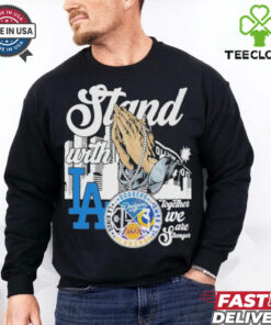 The **Official Stan With Los Angeles Lakers x Los Angeles Rams x Los Angeles Dodgers x Los Angeles Kings Shirt** celebrates Los Angeles' top sports teams. Featuring iconic logos or symbols representing the Lakers, Rams, Dodgers, and Kings, this shirt is perfect for fans who stand united in their support of LA's legendary franchises!