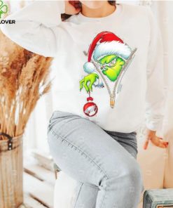 Santa Grinch insdie zipper holding Philadelphia Eagles shirt