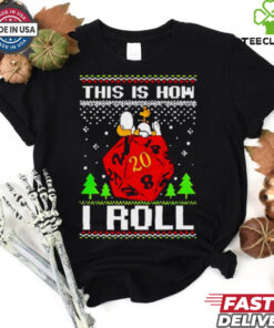 Snoopy and Woodstock atop a D20 This Is How I Roll Ugly Christmas Shirt with a playful, geeky holiday design featuring the iconic characters and a dice theme.
