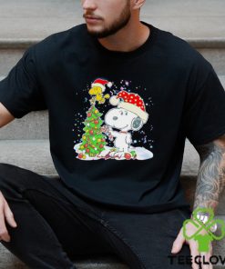 Snoopy and Woodstock wear Santa hats by the pine tree Christmas hoodie, sweater, longsleeve, shirt v-neck, t-shirt