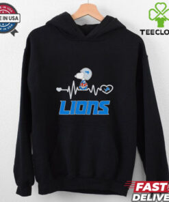 Snoopy Walking on Heartbeat Detroit Lions Football Shirt, featuring a playful design of Snoopy walking along a heartbeat line, with the Detroit Lions logo incorporated. Perfect for fans of both Snoopy and the Lions, blending fun with team spirit.