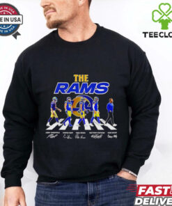 The Rams Abbey Road Jimmy Garoppolo, Cooper Kupp, Puka Nacua Signatures Shirt featuring a creative design inspired by the iconic Abbey Road album cover, incorporating signatures from key Rams players like Garoppolo, Kupp, and Nacua, perfect for fans celebrating these stars and their contributions to the team.