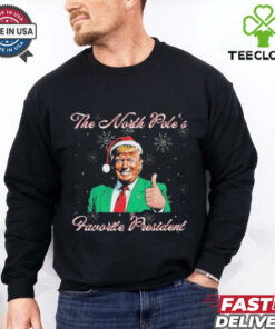 Trump The North Pole’s Favorite President Christmas T-shirts featuring a festive design with a humorous take on Donald Trump as the North Pole's favorite president, adding a holiday twist.