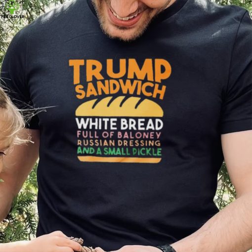 Trunp sandwich white bread full of bakone y russian dressing and a small picke shirt