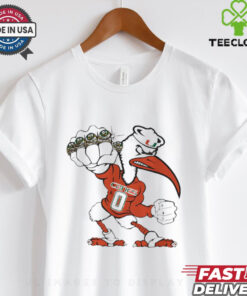 University of Miami Sebastian Championship Rings Mascot Shirt, featuring the iconic Miami Hurricanes mascot, Sebastian the Ibis, along with graphic representations of championship rings. This shirt highlights the team's rich history and success, celebrating their accomplishments with a bold, spirited design. A perfect choice for fans who want to showcase their pride in both the mascot and the university’s athletic achievements.